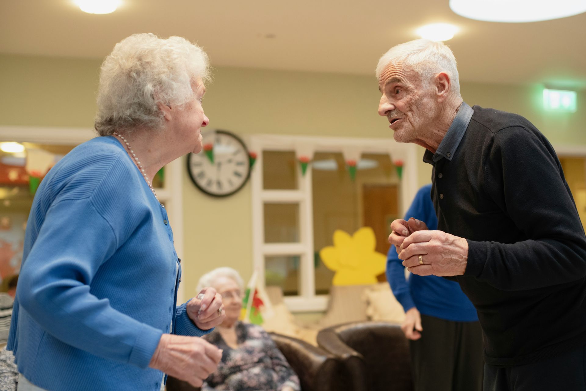 Elderly couple talking in a room